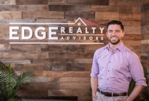 leasing housing - EDGE Realty Matt Gorman standing before EDGE masthead